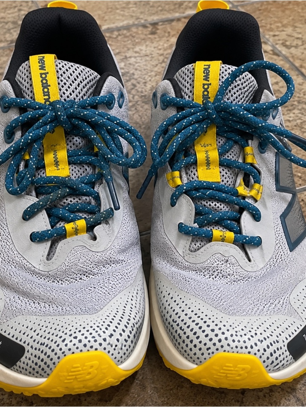 New Balance Kids White Sneakers with Yellow Accents and Teal Laces